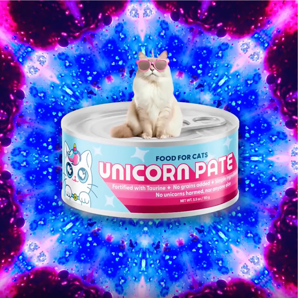 Cat sitting on can of Wild Earth Unicorn Pate cat food with a colorful, space-themed background.